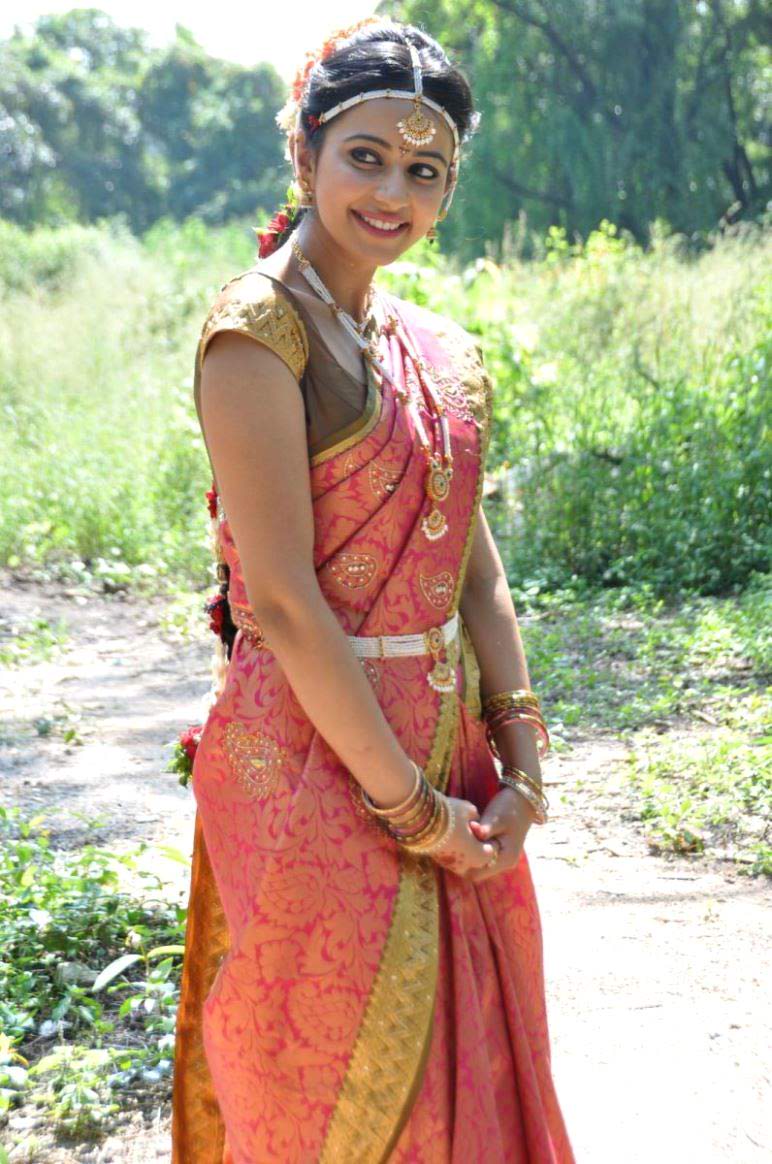 Rakul Preet Singh Profession:  By profession she is a famous Bollywood film actress and a model.  Age: Her age is 25 years old.  Rakul Preet Singh  Height:  Her height is 5 feet 8 inches.  Weight: Her weight is 57 KG.  Rakul Preet Singh  Breast Size:  Her breast size is 33.  Hips Size:  Her hips size is 35.  Rakul Preet Singh Eye Color:  Her eye color is brown in shade.  Hair Color:  Her hair color is  blackish brown in shade.  Rakul Preet Singh Weight In Pounds:   Her weight in pounds is 125.5.  Net Worth:  Her net worth in her so far career is not known.  Rakul Preet Singh Dress Size:   Her dress size is 6.  Skin Color:   Her skin color is fair.  Rakul Preet Singh Without Makeup:  She looks quite ugly as without makeup.