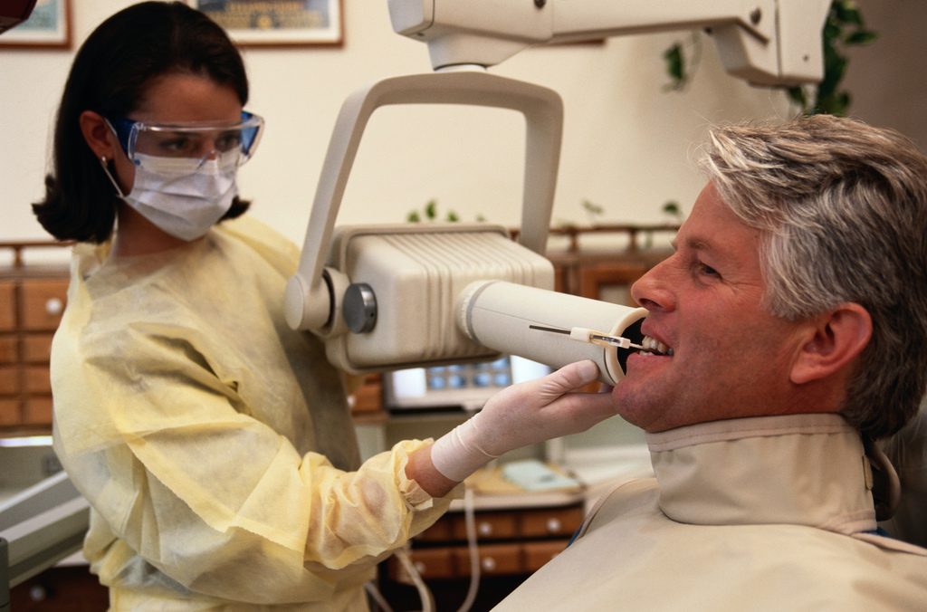 Dentist taking xray of teeth